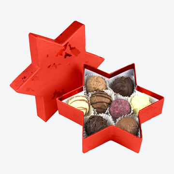 Produktbild für 'Exquisite handgefertigte Trüffelpralinen in weihnachtlicher Sternschachtel'